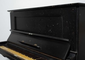 Piano with shattered pieces of glass stuck in